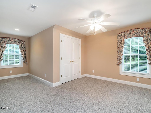 6843 Sawyer Rd, Liberty, NC 27298 - unfurnished bedroom featuring multiple windows, carpet, and ceiling fan
