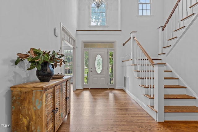 6104 Spicewood Dr, Fuquay Varina, NC 27526 - entrance foyer with wood finished floors, a high ceiling, and stairs