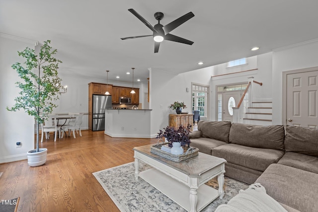 6104 Spicewood Dr, Fuquay Varina, NC 27526 - living area with ceiling fan, light wood-style floors, recessed lighting, crown molding, and stairway