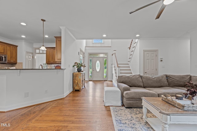 6104 Spicewood Dr, Fuquay Varina, NC 27526 - living area with a ceiling fan, ornamental molding, light wood-style floors, recessed lighting, and stairs