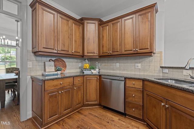 6104 Spicewood Dr, Fuquay Varina, NC 27526 - kitchen with stainless steel dishwasher, wood finished floors, brown cabinets, dark stone counters, and ornamental molding
