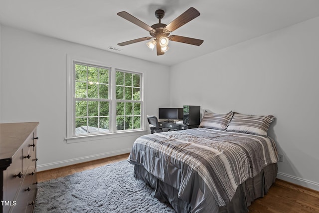 6104 Spicewood Dr, Fuquay Varina, NC 27526 - bedroom with multiple windows, wood finished floors, and ceiling fan