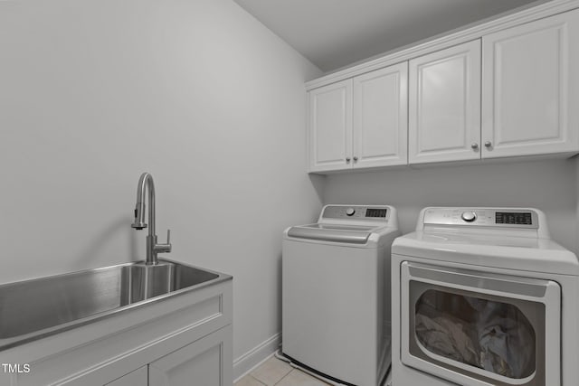 6104 Spicewood Dr, Fuquay Varina, NC 27526 - laundry area with washing machine and dryer, cabinet space, and light tile patterned flooring