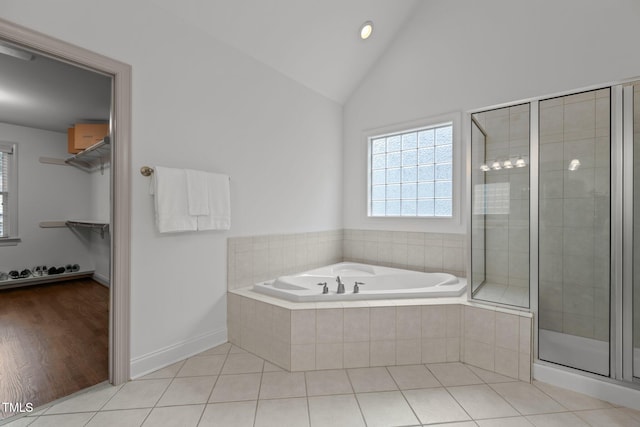 6104 Spicewood Dr, Fuquay Varina, NC 27526 - bathroom with a bath, a shower stall, a walk in closet, high vaulted ceiling, and tile patterned floors