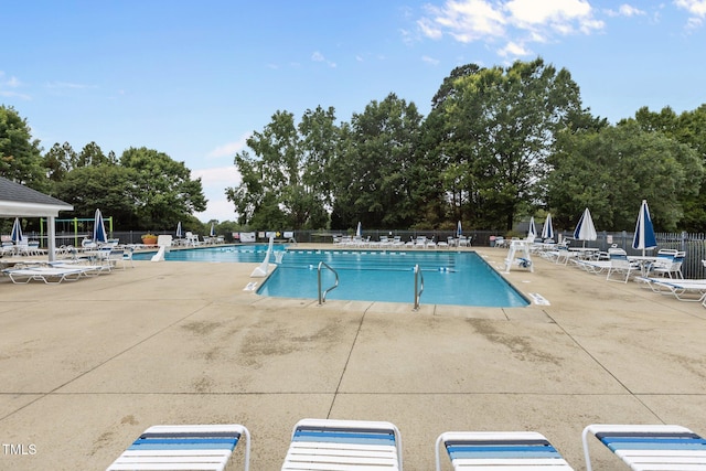 6104 Spicewood Dr, Fuquay Varina, NC 27526 - community pool featuring a patio area and view of wooded area