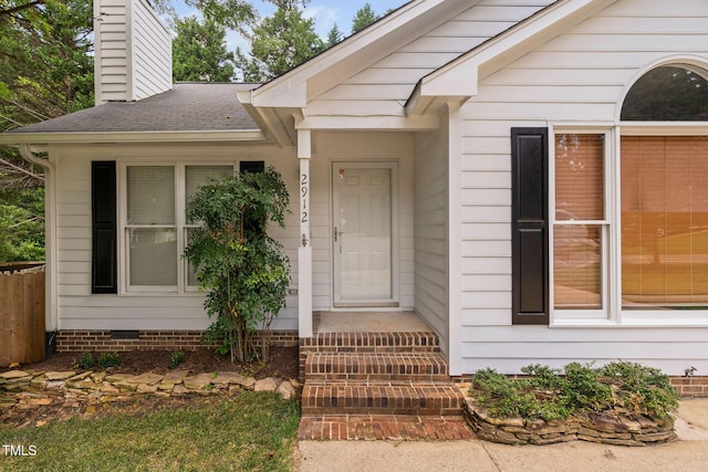 2912 Enson Pl, Raleigh, NC 27603 - property entrance featuring a chimney, roof with shingles, and crawl space