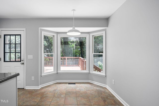 2912 Enson Pl, Raleigh, NC 27603 - unfurnished dining area featuring healthy amount of natural light and stone finish flooring