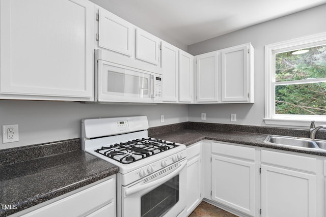 2912 Enson Pl, Raleigh, NC 27603 - kitchen featuring white appliances, white cabinets, and dark countertops