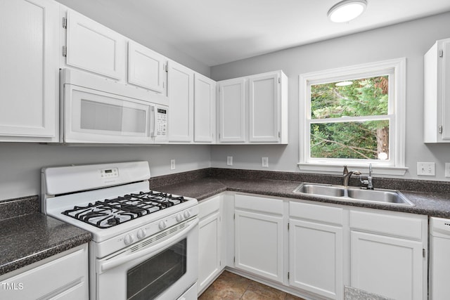 2912 Enson Pl, Raleigh, NC 27603 - kitchen with white appliances, dark countertops, and white cabinetry