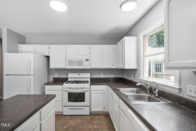 2912 Enson Pl, Raleigh, NC 27603 - kitchen with white appliances, white cabinetry, dark countertops, and stone finish flooring