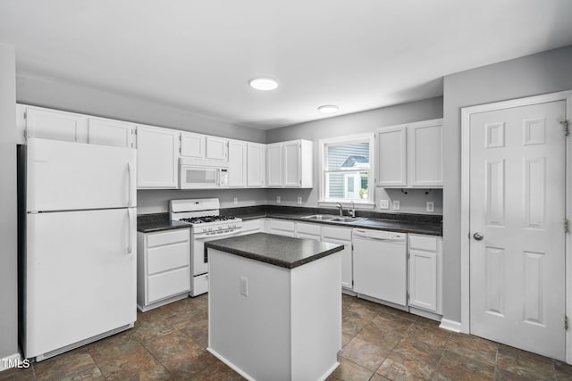 2912 Enson Pl, Raleigh, NC 27603 - kitchen featuring white appliances, stone finish flooring, white cabinets, and dark countertops