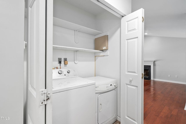 2912 Enson Pl, Raleigh, NC 27603 - washroom with separate washer and dryer, wood finished floors, and a fireplace