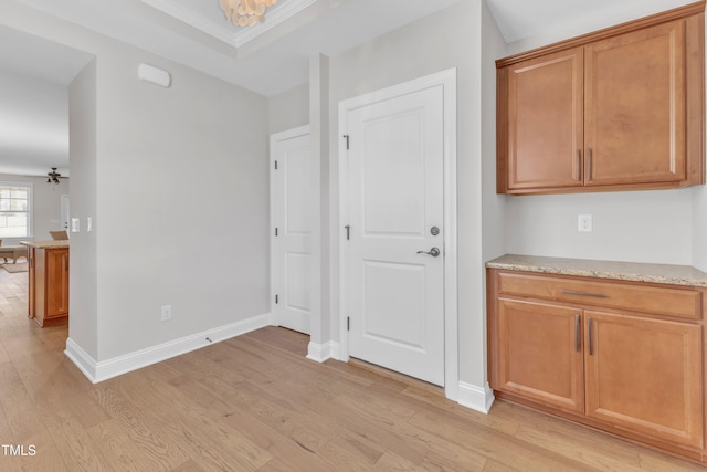 1003 Branwell Dr, Durham, NC 27703 - interior space featuring light wood-style flooring, brown cabinets, light stone counters, and ornamental molding