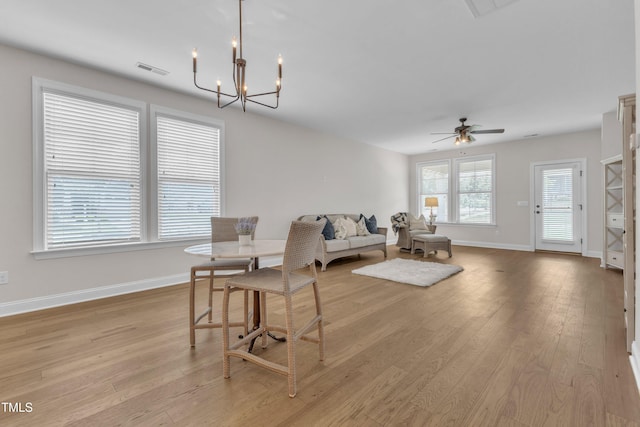 1003 Branwell Dr, Durham, NC 27703 - dining space with light wood finished floors, ceiling fan, and a chandelier