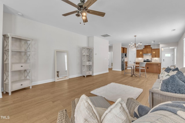 1003 Branwell Dr, Durham, NC 27703 - living area featuring ceiling fan, a chandelier, and light wood-style flooring