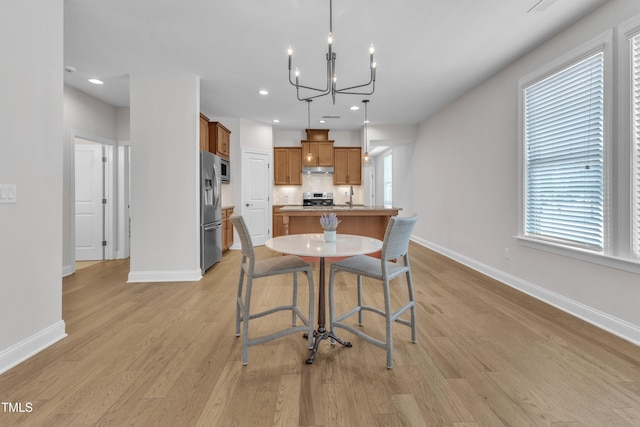 1003 Branwell Dr, Durham, NC 27703 - dining room with a chandelier, light wood-style flooring, healthy amount of natural light, and recessed lighting