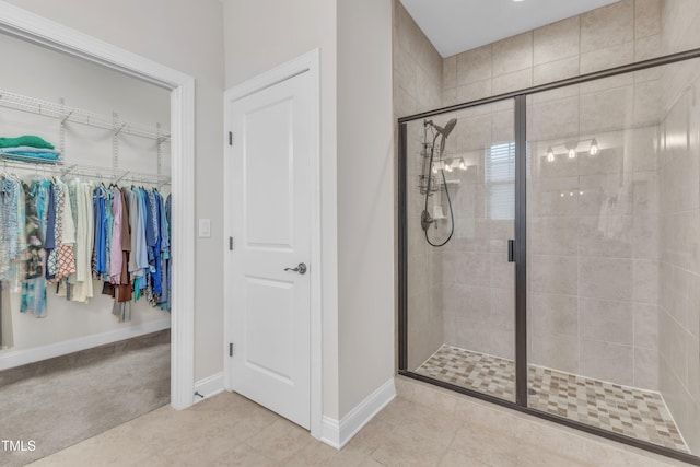 1003 Branwell Dr, Durham, NC 27703 - bathroom featuring a stall shower, tile patterned flooring, and a walk in closet
