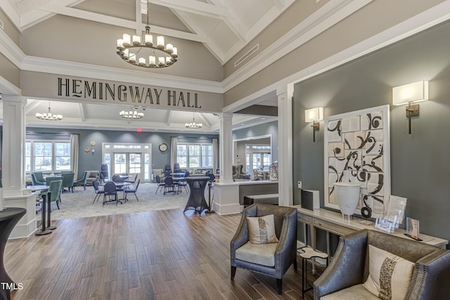 1003 Branwell Dr, Durham, NC 27703 - living room featuring decorative columns, a chandelier, beam ceiling, wood finished floors, and high vaulted ceiling