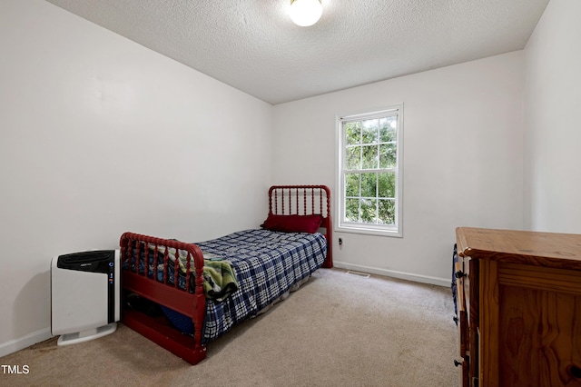 405 E Maple Ave, Holly Springs, NC 27540 - carpeted bedroom with a textured ceiling and baseboards