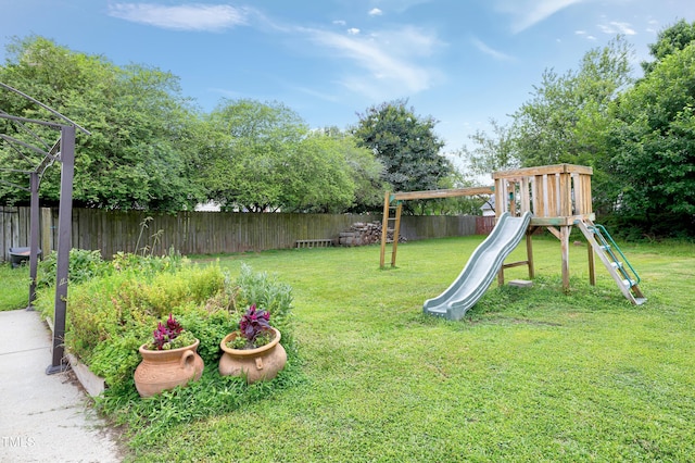405 E Maple Ave, Holly Springs, NC 27540 - fenced backyard featuring a playground