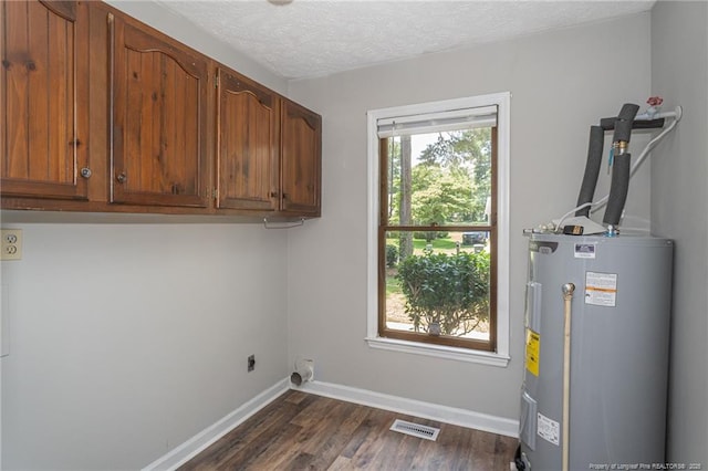 3516 Worley St, Fayetteville, NC 28311 - laundry room featuring water heater, electric dryer hookup, cabinet space, dark wood-style floors, and a textured ceiling