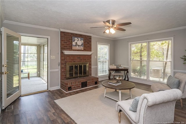 3516 Worley St, Fayetteville, NC 28311 - living area featuring wood finished floors, ornamental molding, a ceiling fan, a textured ceiling, and a fireplace
