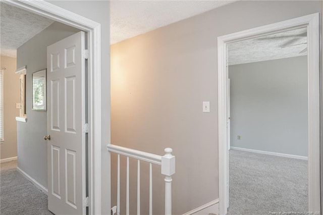 3516 Worley St, Fayetteville, NC 28311 - hall featuring a textured ceiling, carpet flooring, and an upstairs landing