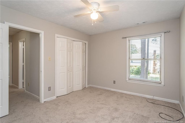 3516 Worley St, Fayetteville, NC 28311 - unfurnished bedroom with carpet flooring, a closet, a textured ceiling, and a ceiling fan