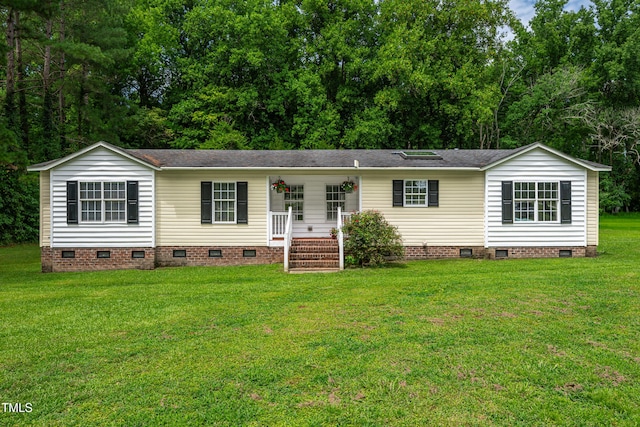 5568 N NC Highway 58, Nashville, NC 27856 - view of front of house featuring crawl space, a front yard, and roof with shingles
