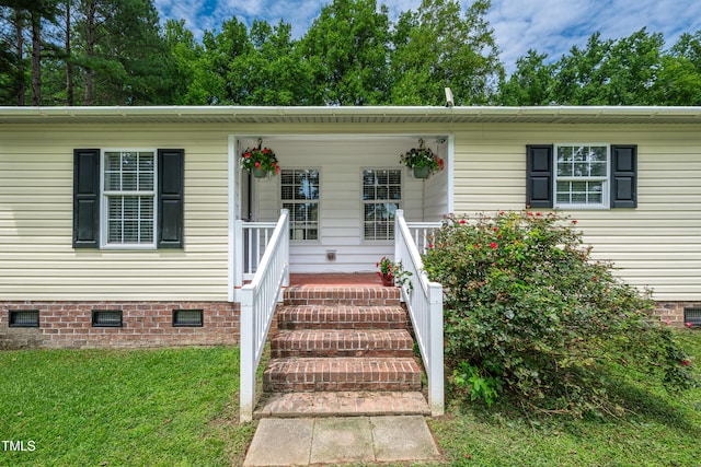 5568 N NC Highway 58, Nashville, NC 27856 - view of front of home featuring crawl space, a front yard, and covered porch