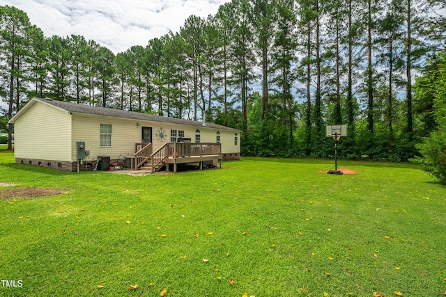 5568 N NC Highway 58, Nashville, NC 27856 - rear view of house featuring crawl space, a wooden deck, and a lawn