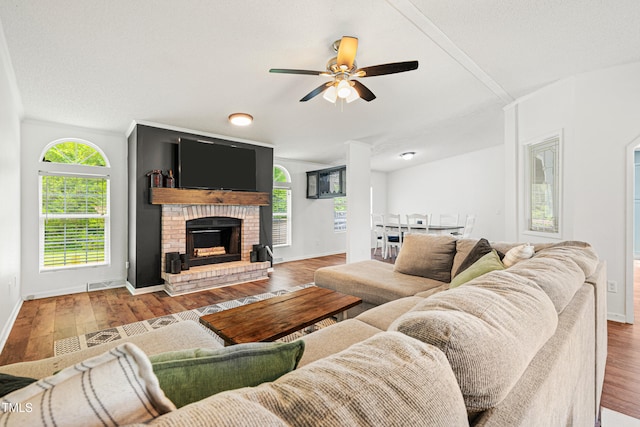 5568 N NC Highway 58, Nashville, NC 27856 - living room featuring a ceiling fan, wood finished floors, and a fireplace