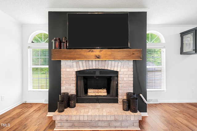 5568 N NC Highway 58, Nashville, NC 27856 - detailed view of wood finished floors, a textured ceiling, a brick fireplace, and ornamental molding