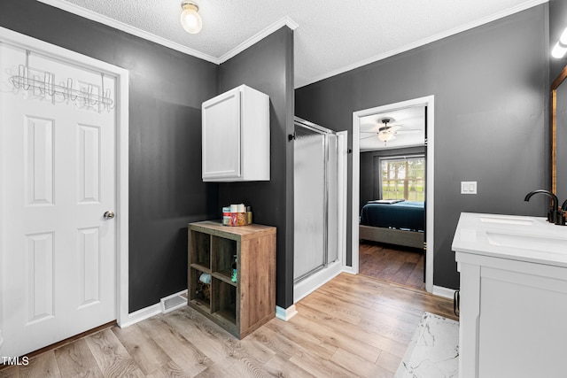 5568 N NC Highway 58, Nashville, NC 27856 - ensuite bathroom featuring wood finished floors, a stall shower, ceiling fan, crown molding, and double vanity