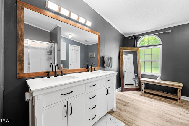 5568 N NC Highway 58, Nashville, NC 27856 - full bath with ornamental molding, double vanity, a shower stall, a textured ceiling, and wood finished floors