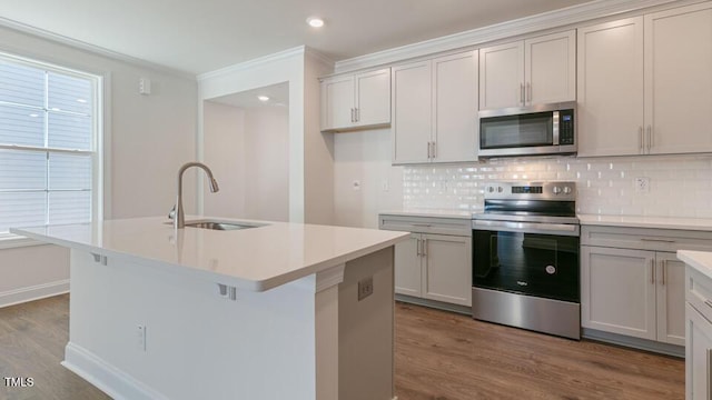 2304 Sugar Cone Way, Fuquay Varina, NC 27526 - kitchen featuring stainless steel appliances, wood finished floors, tasteful backsplash, ornamental molding, and recessed lighting