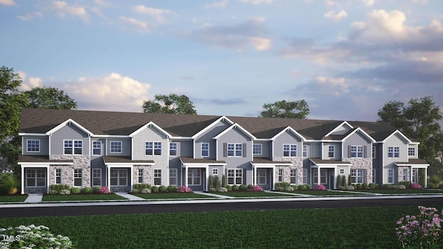 2304 Sugar Cone Way, Fuquay Varina, NC 27526 - townhome / multi-family property with stone siding, a front lawn, and a residential view