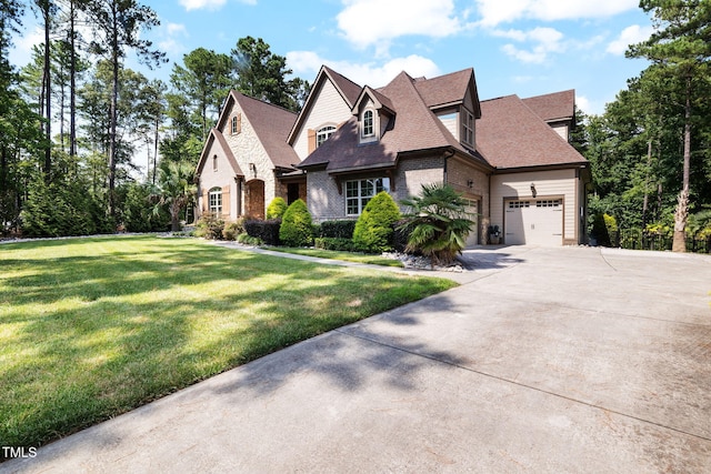 2101 Blue Haven Ct, Wake Forest, NC 27587 - french country style house with concrete driveway, brick siding, a front lawn, an attached garage, and roof with shingles