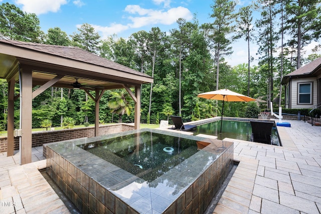 2101 Blue Haven Ct, Wake Forest, NC 27587 - outdoor pool with an in-ground hot tub, a patio area, view of wooded area, and ceiling fan