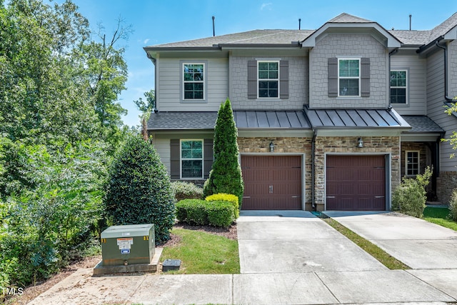677 Wickham Ridge Rd, Apex, NC 27539 - view of front of house featuring driveway, an attached garage, a standing seam roof, and roof with shingles