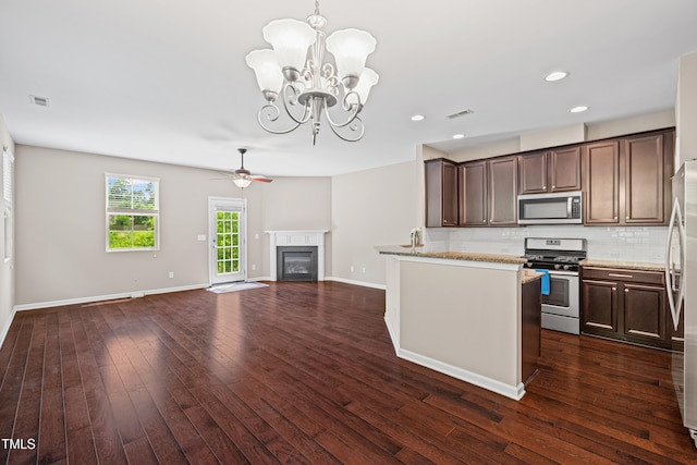 677 Wickham Ridge Rd, Apex, NC 27539 - kitchen featuring appliances with stainless steel finishes, dark brown cabinetry, decorative backsplash, a chandelier, and recessed lighting
