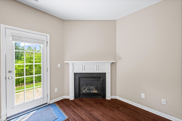 677 Wickham Ridge Rd, Apex, NC 27539 - unfurnished living room featuring dark wood-style flooring and a glass covered fireplace