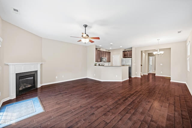 677 Wickham Ridge Rd, Apex, NC 27539 - unfurnished living room featuring a chandelier, dark wood finished floors, a glass covered fireplace, ceiling fan, and recessed lighting