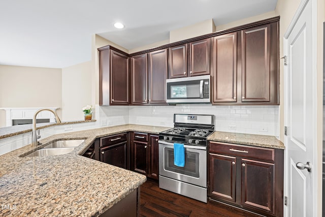 677 Wickham Ridge Rd, Apex, NC 27539 - kitchen featuring appliances with stainless steel finishes, dark wood-type flooring, light stone counters, dark brown cabinetry, and recessed lighting