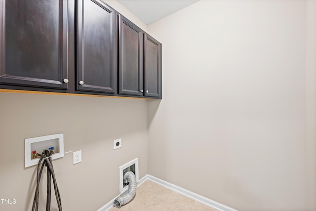 677 Wickham Ridge Rd, Apex, NC 27539 - laundry area with cabinet space, hookup for an electric dryer, hookup for a washing machine, and light tile patterned flooring
