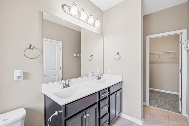677 Wickham Ridge Rd, Apex, NC 27539 - bathroom with double vanity, tile patterned floors, and a spacious closet
