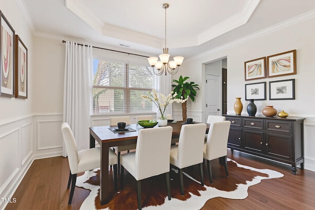 4 Seawell Ct, Durham, NC 27703 - dining room with a chandelier, a decorative wall, dark wood-type flooring, ornamental molding, and wainscoting