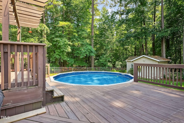 116 Seminole Dr, Louisburg, NC 27549 - view of swimming pool with a deck, an outdoor structure, and view of wooded area