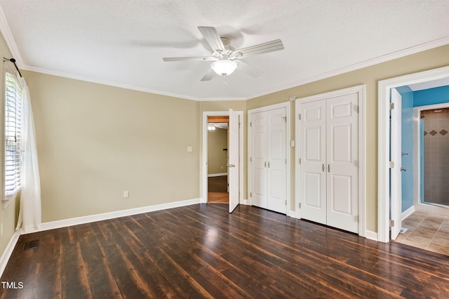116 Seminole Dr, Louisburg, NC 27549 - unfurnished bedroom with wood finished floors, two closets, ornamental molding, ensuite bath, and a ceiling fan