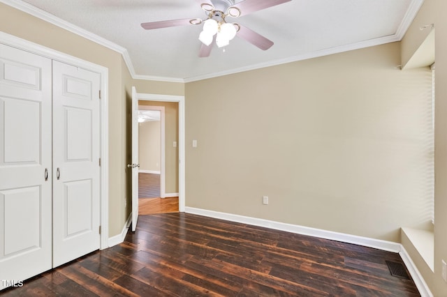 116 Seminole Dr, Louisburg, NC 27549 - unfurnished bedroom featuring dark wood-style floors, ornamental molding, a closet, and a ceiling fan